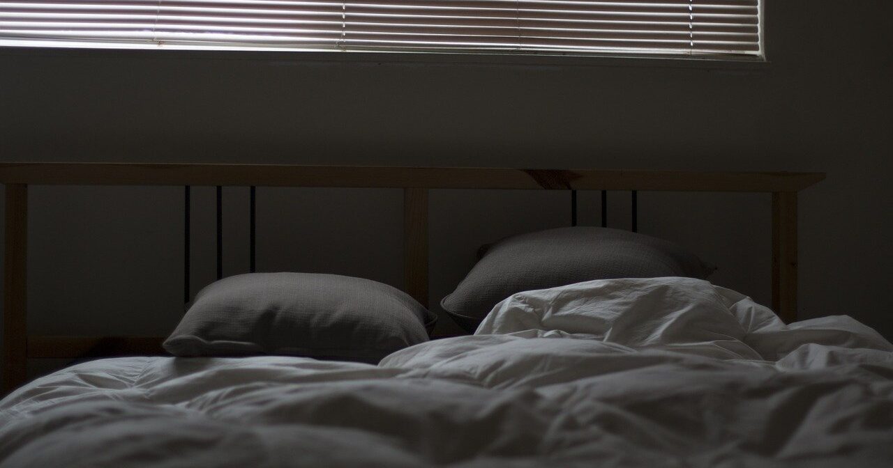 a bed in a darkened room for a quality rest